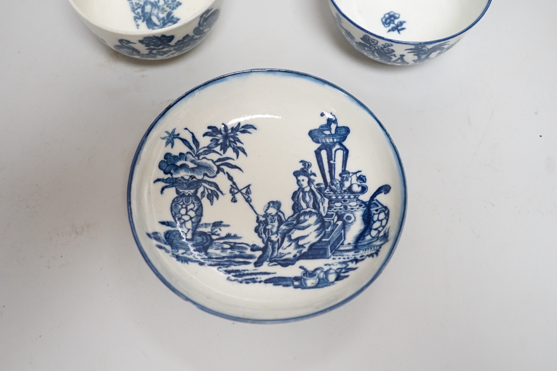 An 18th century Caughley teabowl and saucer printed with 'Mother and Child' and 'Birds in Branches', saucer 12cms diameter